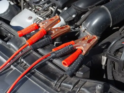 Kable rozruchowe podłączone do akumulatora, bo auto nie odpala, mimo że akumulator jest sprawny.