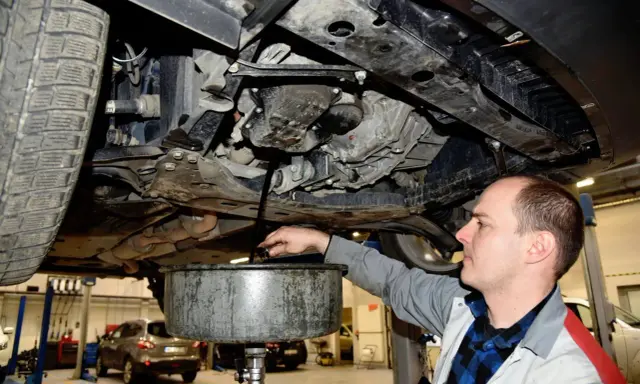 Mechanik wymienia olej w Skodzie Fabii. Regularna wymiana oleju co 15 tys. km lub raz w roku zapewnia długą żywotność silnika.
