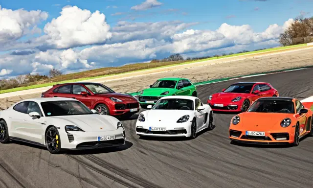 Różne rodzaje Porsche: biały Taycan, czerwony Cayenne, zielony Macan, biały Cayman, czerwona Panamera Sport Turismo i pomarańczowy 911 na torze wyścigowym.